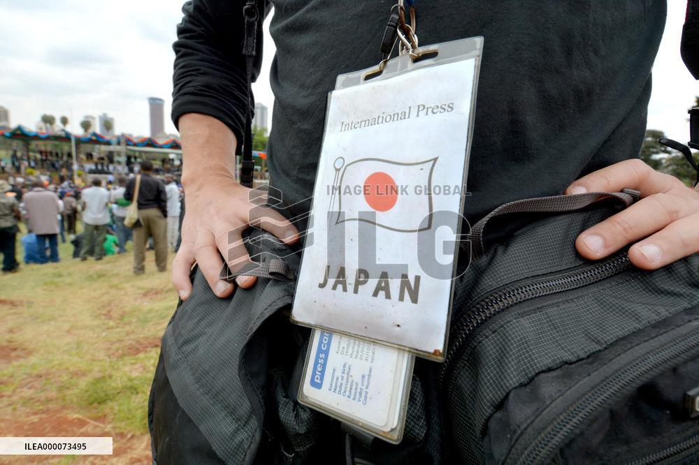 Japanese journalist hangs press ID showing nationality