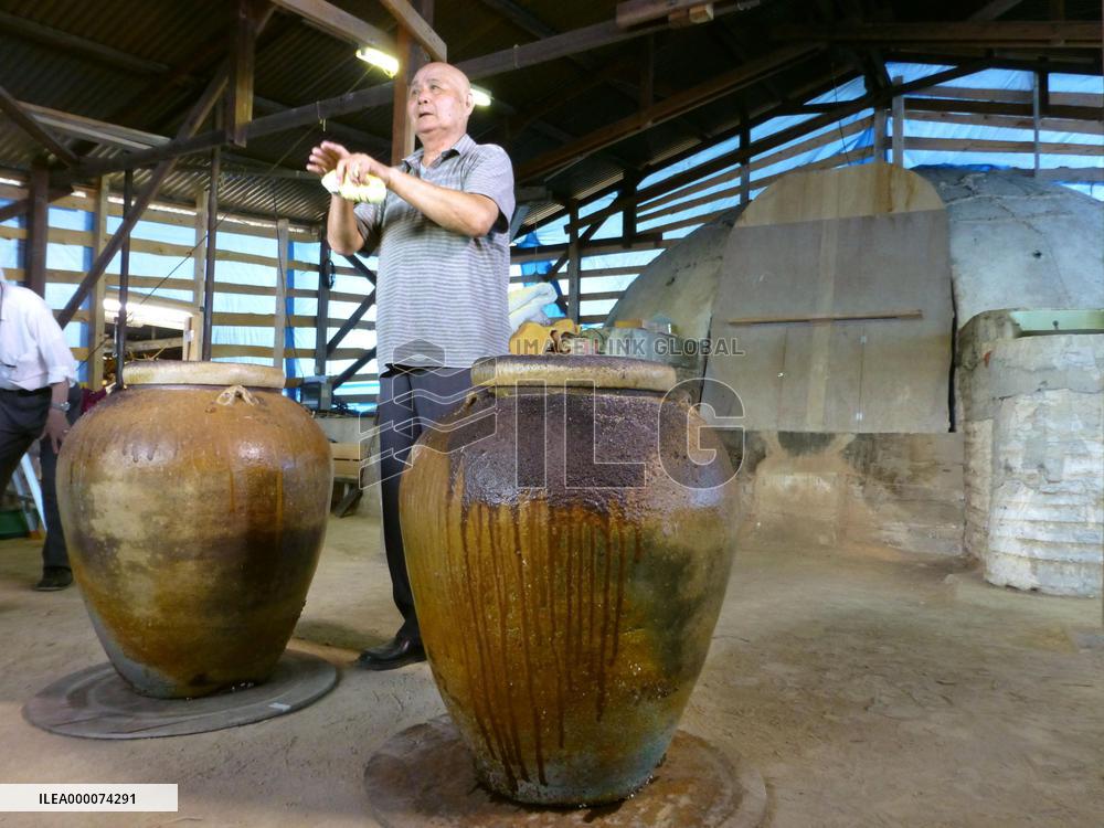Potter checks products fired in huge kiln in western Japan