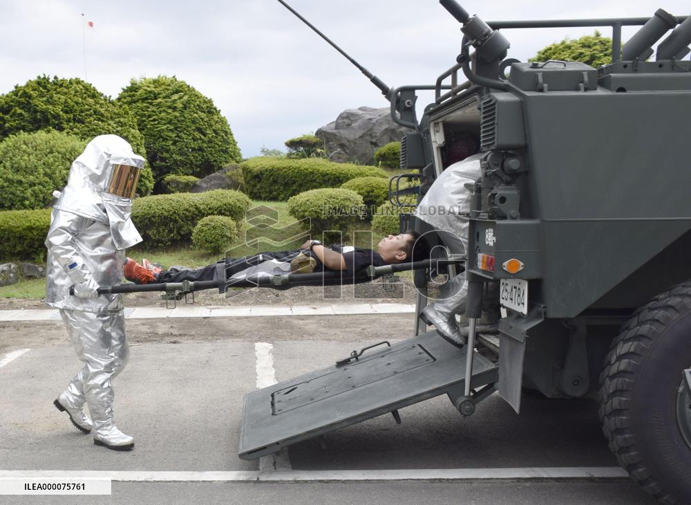 Japan army demonstrates transfer of person injured in volcanic eruption