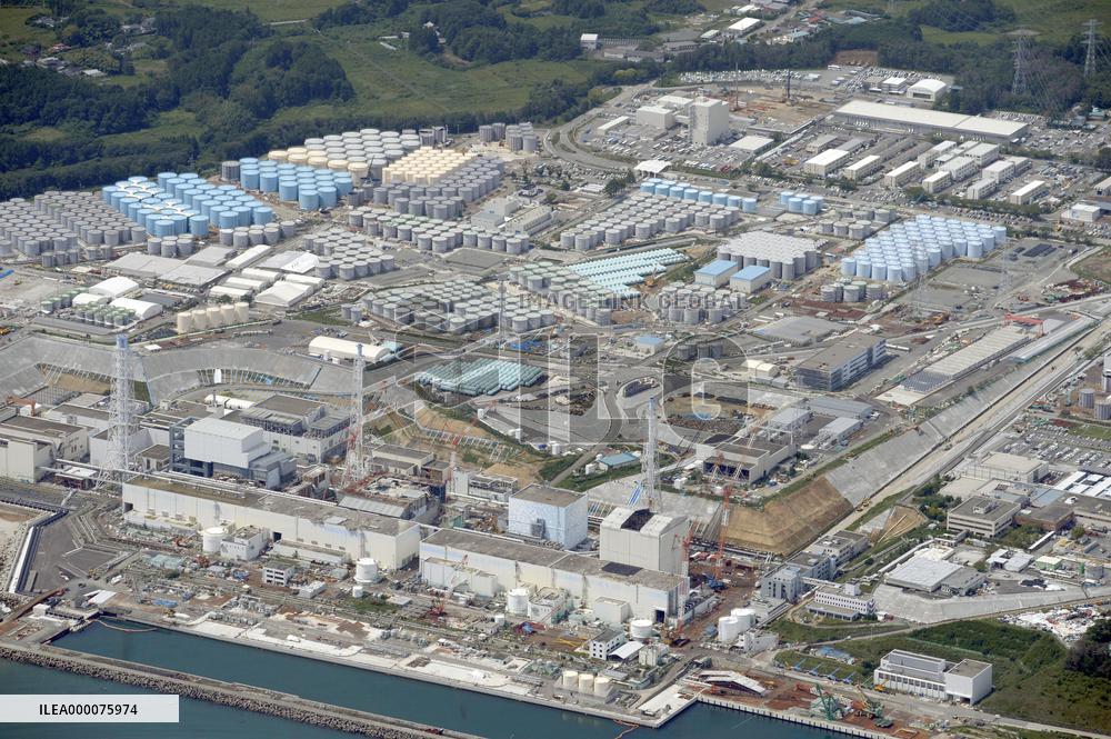 Sprawling Fukushima nuke plant with piles of polluted waste stored