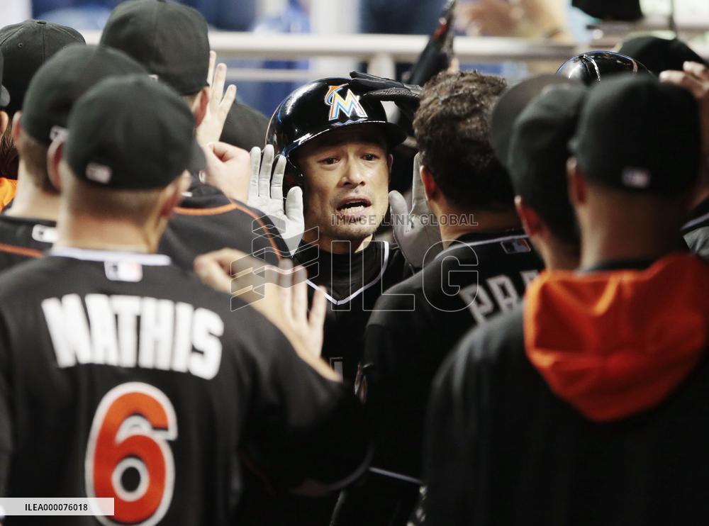 Ichiro welcomed by teammates after touching home plate