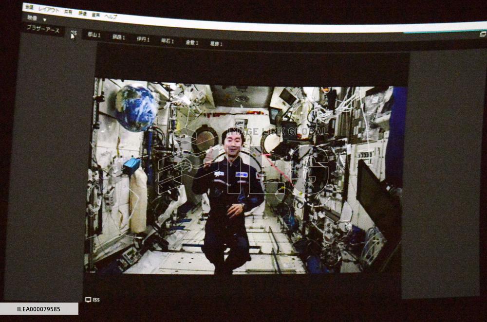 Astronaut communicates with students