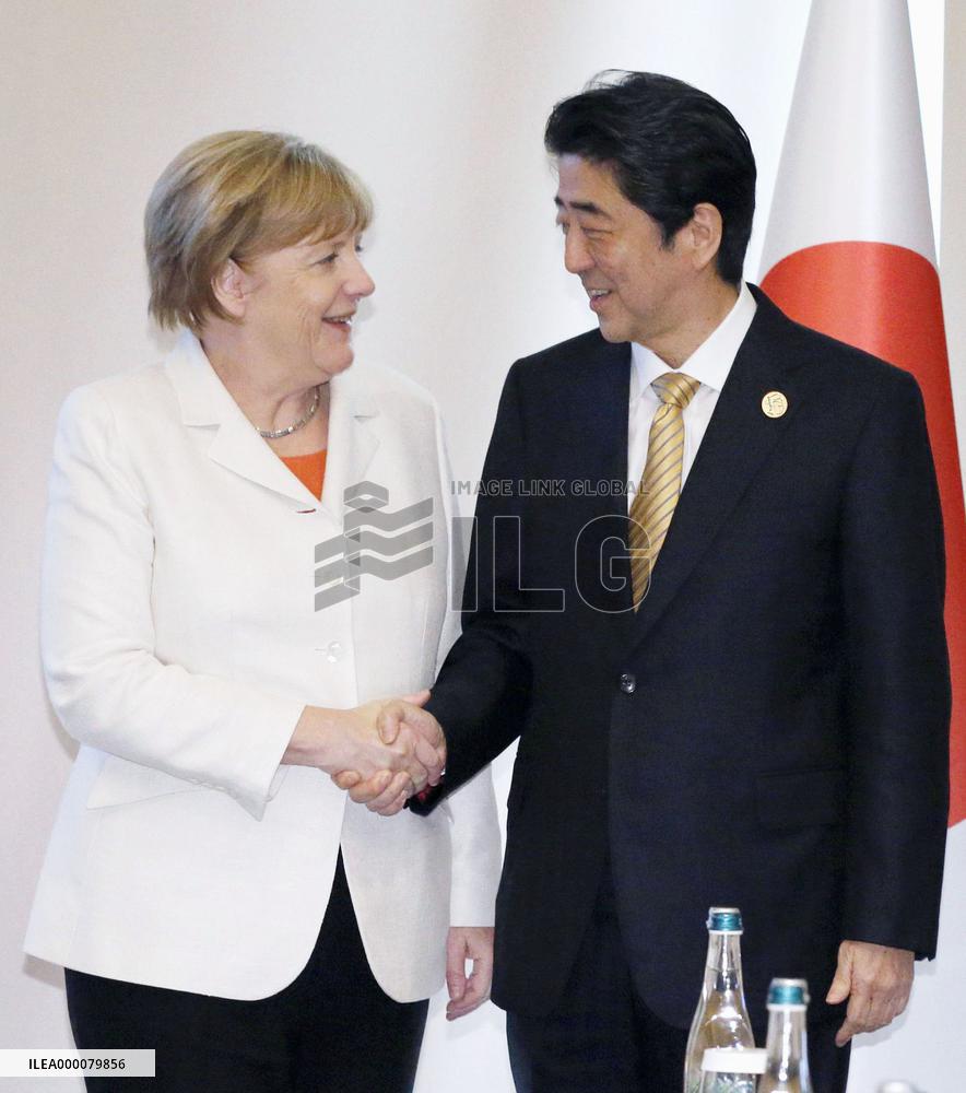 Japan's Abe, Germany's Merkel meet in Turkey