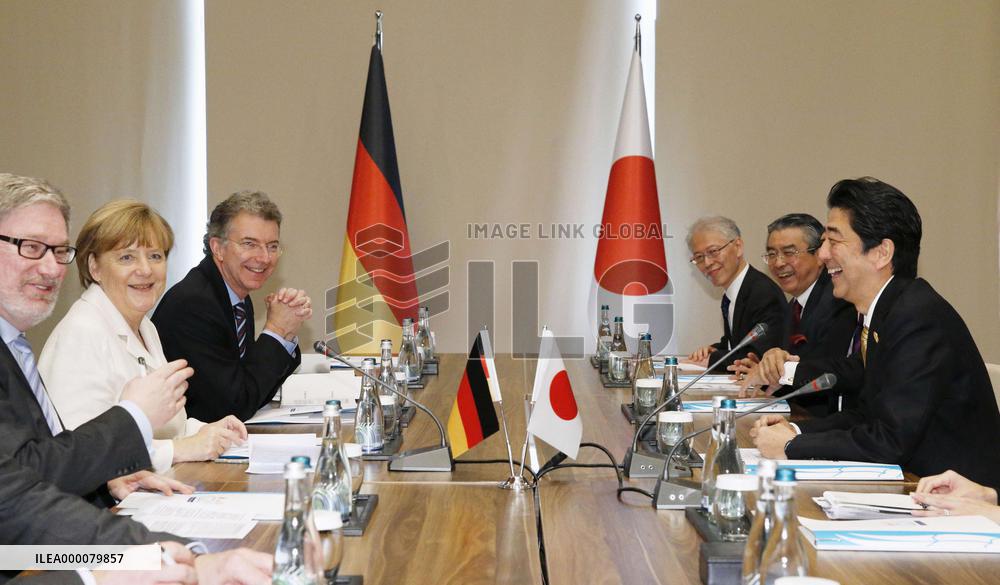 Japan's Abe, Germany's Merkel meet in Turkey