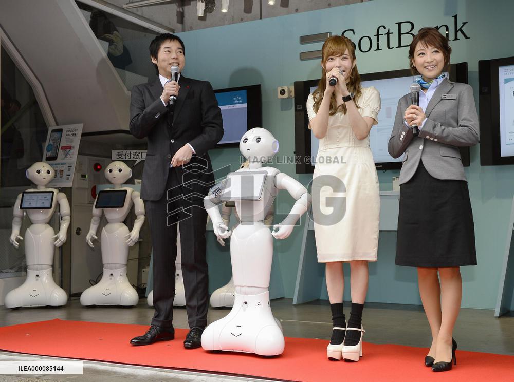 Pepper humanoid robots meet clients at smartphone shop