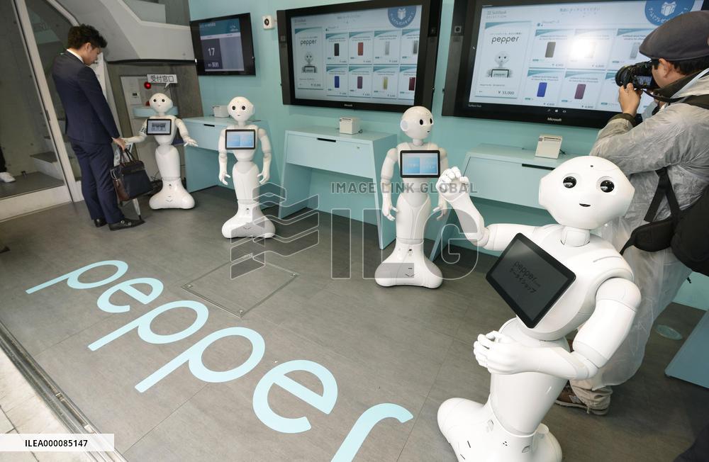 Pepper humanoid robots meet clients at smartphone shop