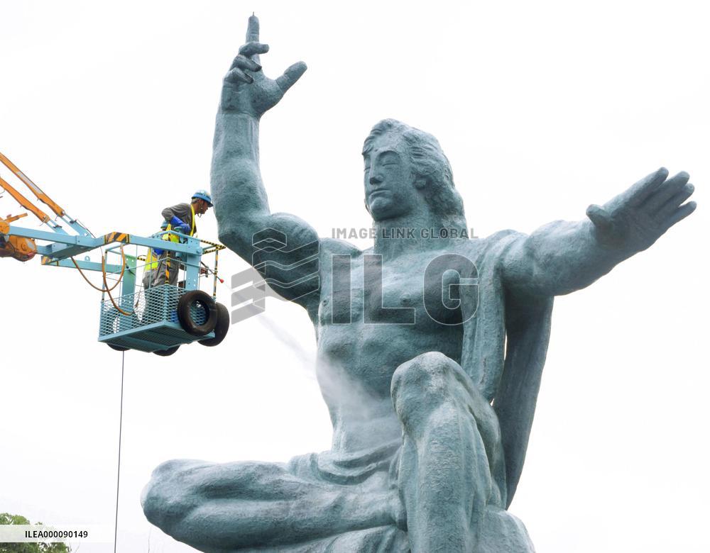 Peace Statue in Nagasaki is cleaned