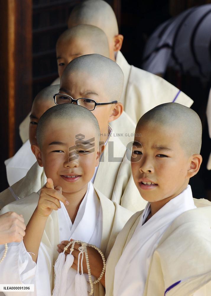 Children attend ceremony to become Buddhist monks