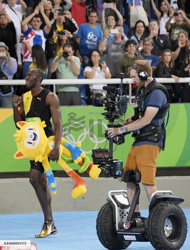 Olympic scenes: Bolt followed by Segway-like vehicle