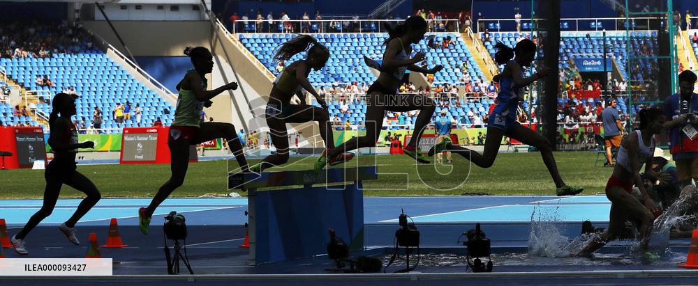 Olympic scenes: Steeplechase runners clear water pit