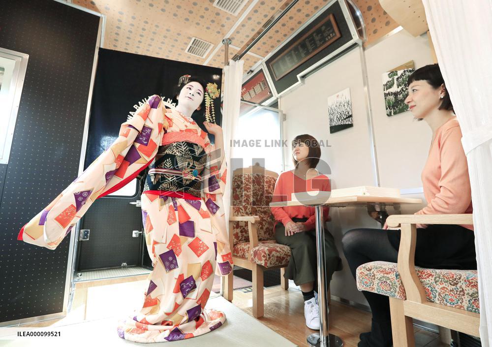 Geisha performance in local train car
