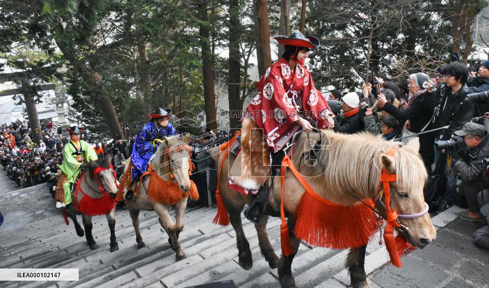 Horse riders ascend steps of Hokkaido shrine