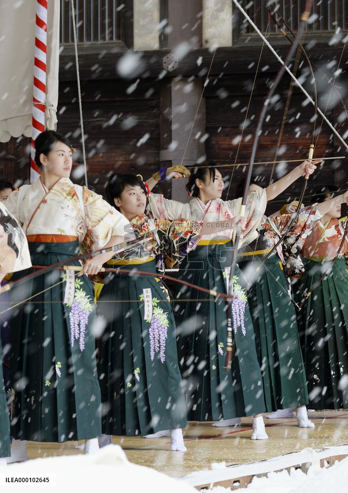 Young people celebrating coming-of-age shoot arrows