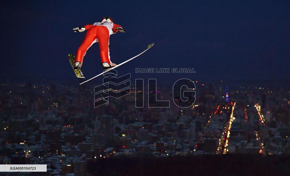 Japanese ski jumper Nakamura leaps toward Sapporo night view