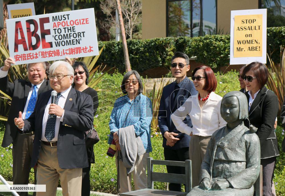 Congressman stands beside statue symbolizing "comfort women"