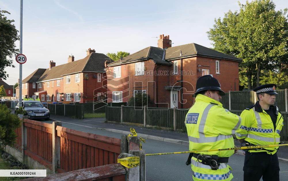 Police stand guard near house of suspected terrorist in Manchester