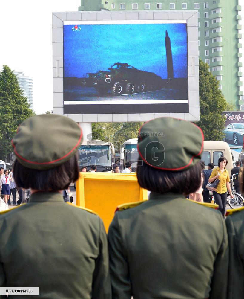 North Koreans watch news of their country's missile launch