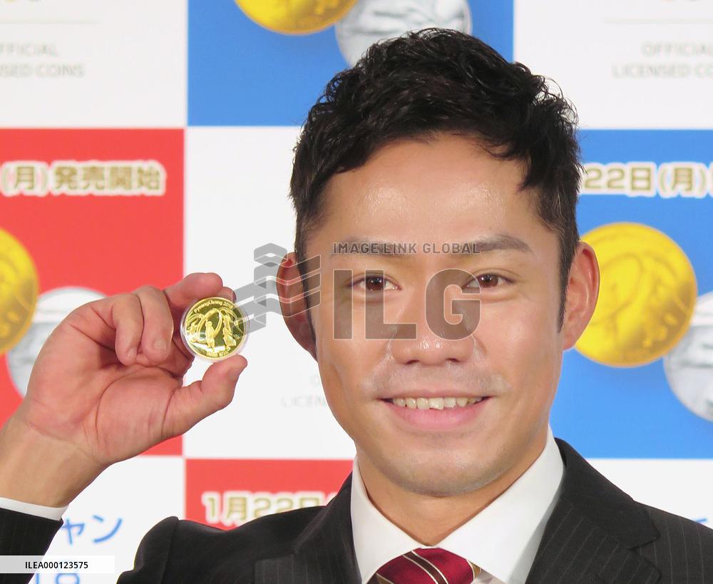 Figure skater Daisuke Takahashi with Olympic coin