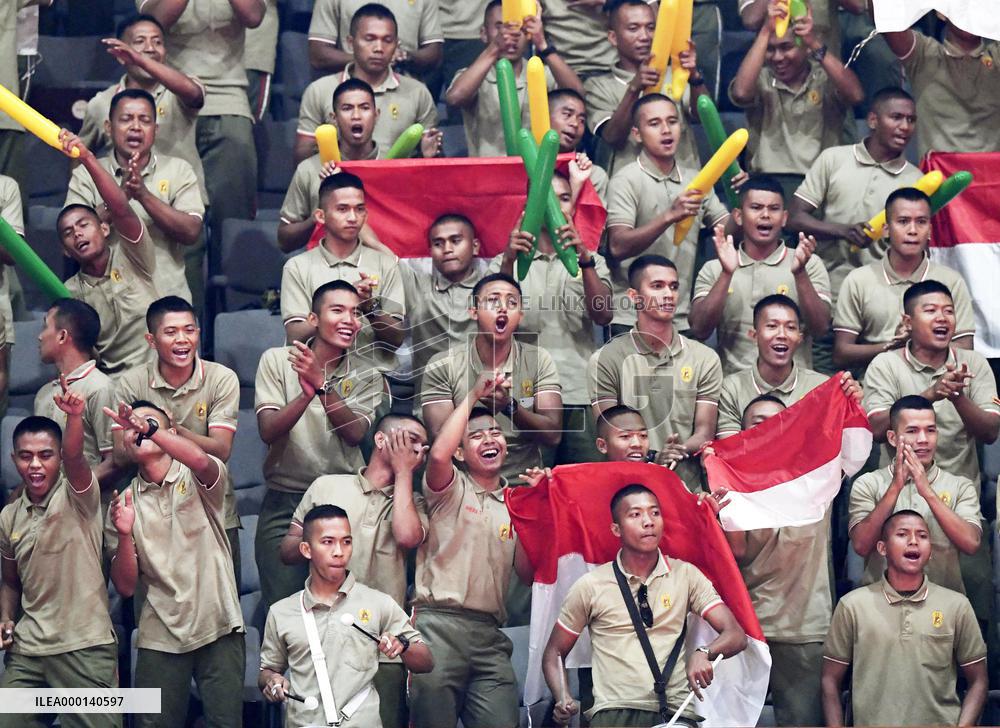 Indonesian soldiers cheer at Asian Games