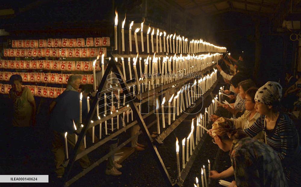 Well-wishers light candles at shrine in western Japan