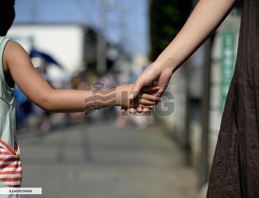 Mother and child holding hands