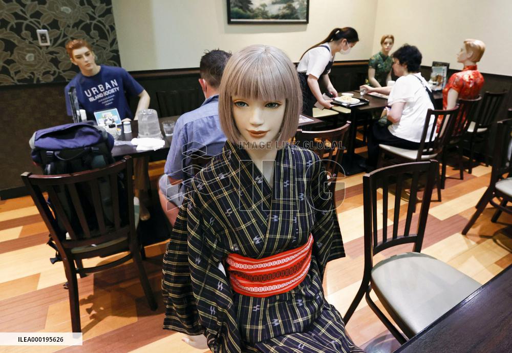 Mannequins seating at restaurant