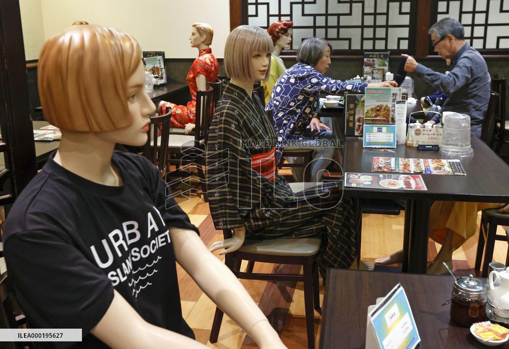 Mannequins seating at restaurant