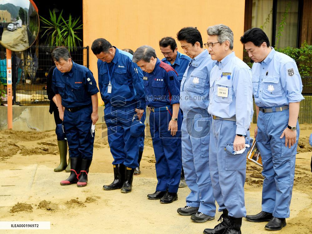 Japan PM Abe visits flood-hit southwestern Japan