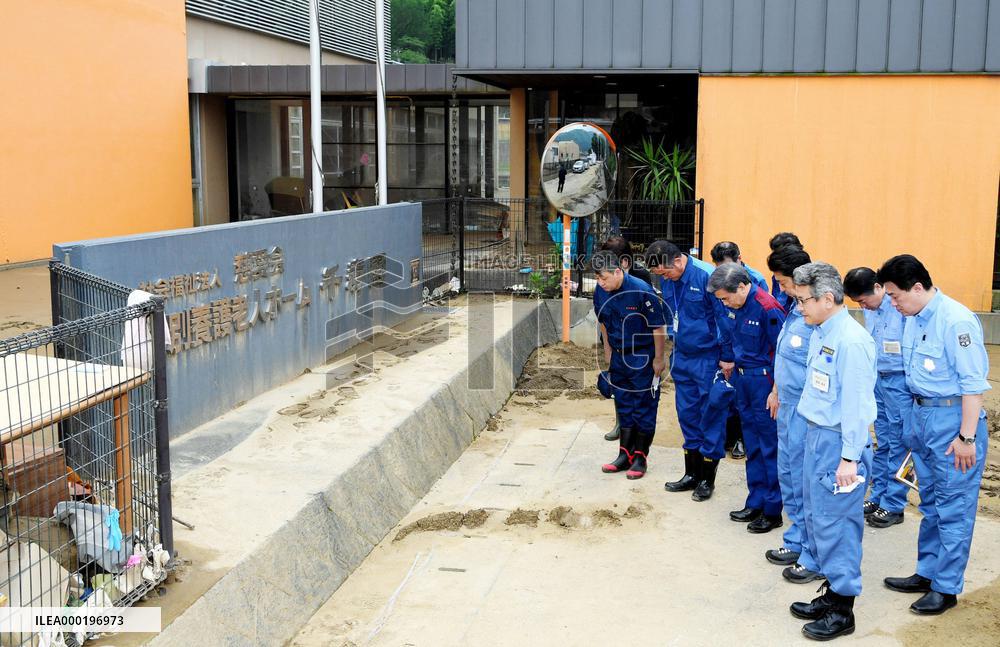 Japan PM Abe visits flood-hit southwestern Japan