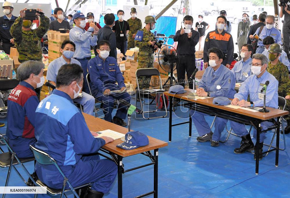 Japan PM Abe visits flood-hit southwestern Japan