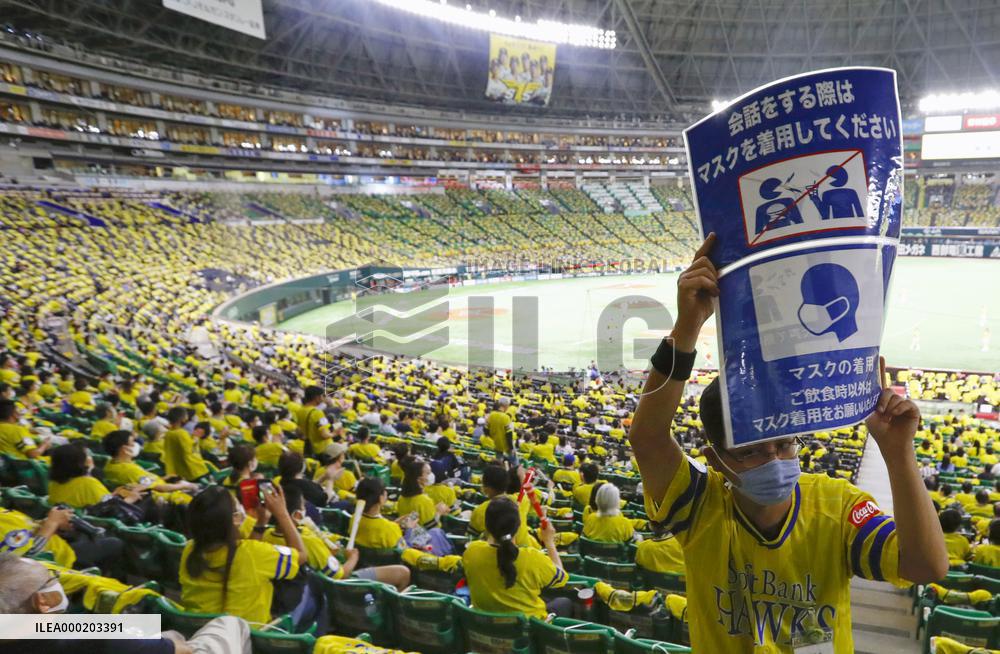 Japan eases virus rule to allow more people at sports, movie venues