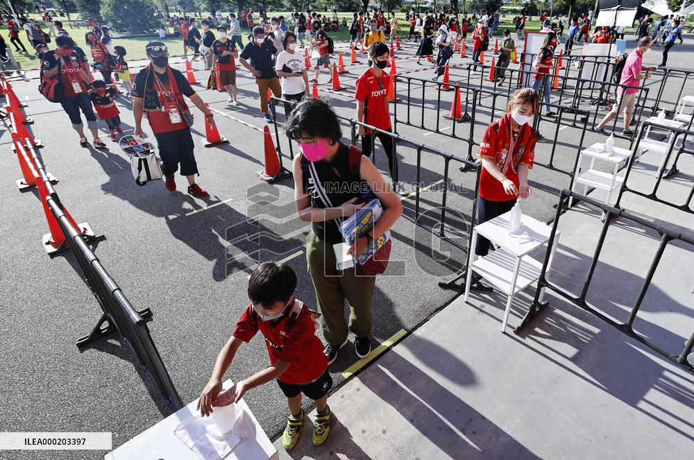 Japan eases virus rule to allow more people at sports, movie venues