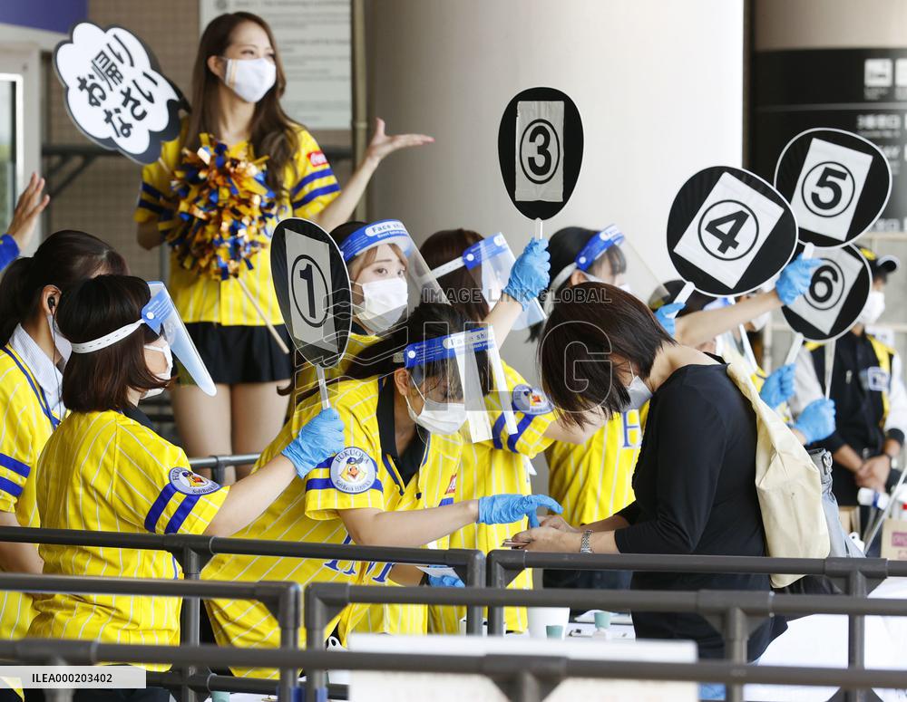 Japan eases virus rule to allow more people at sports, movie venues