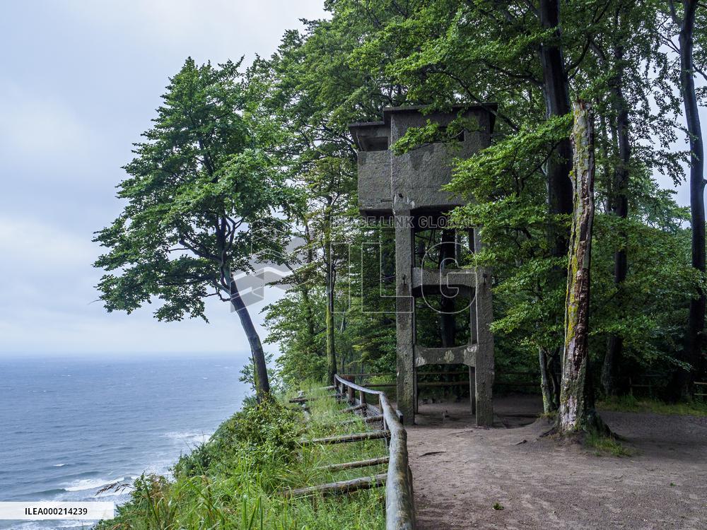 Watchtower and a tree over frothy turbulent sea