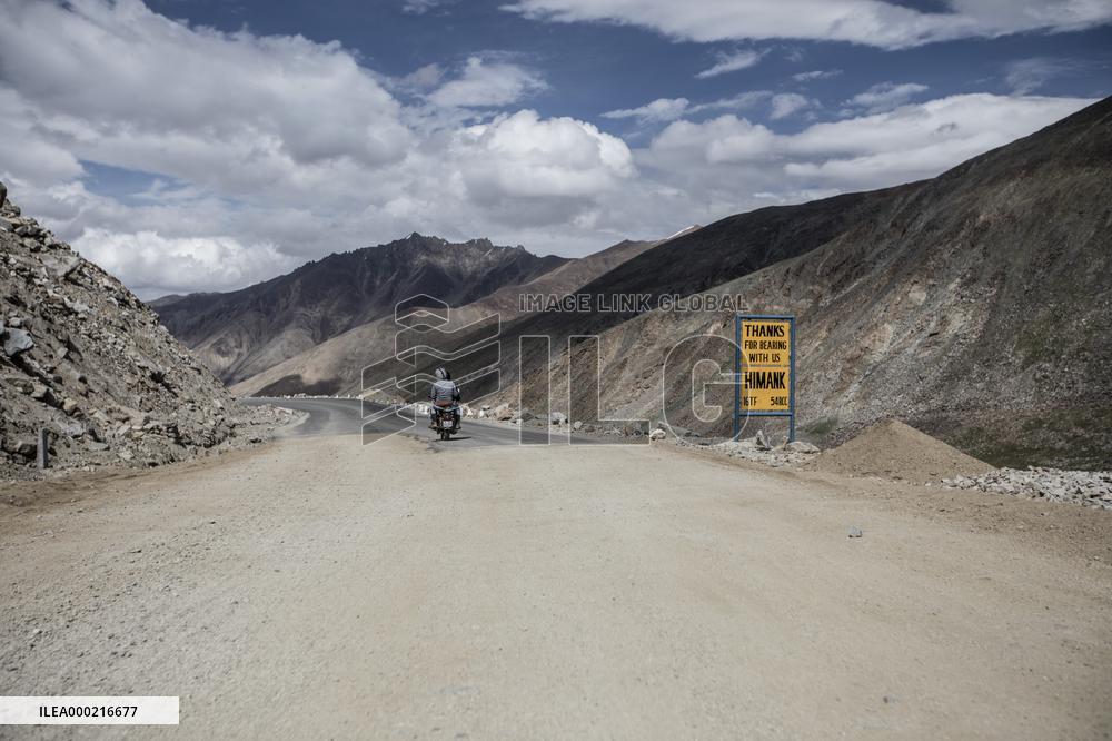 Mountain road, motorcycle, road sign, Himalayas, Ladakh, Kashmir, India