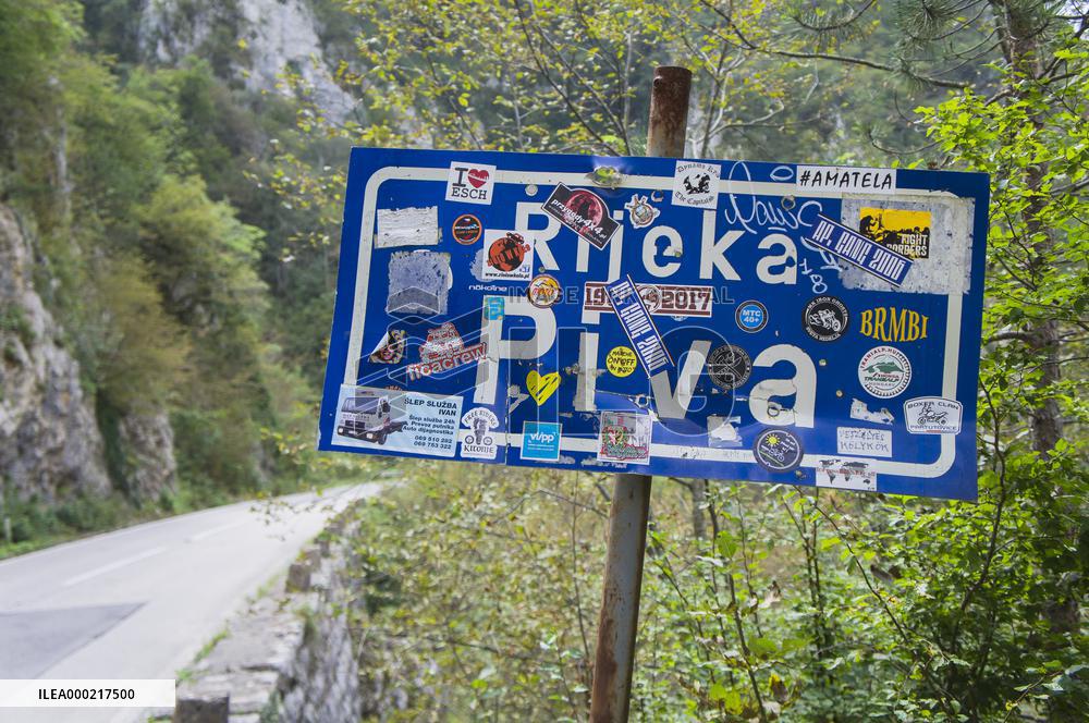 the Piva River sign covered with stickers