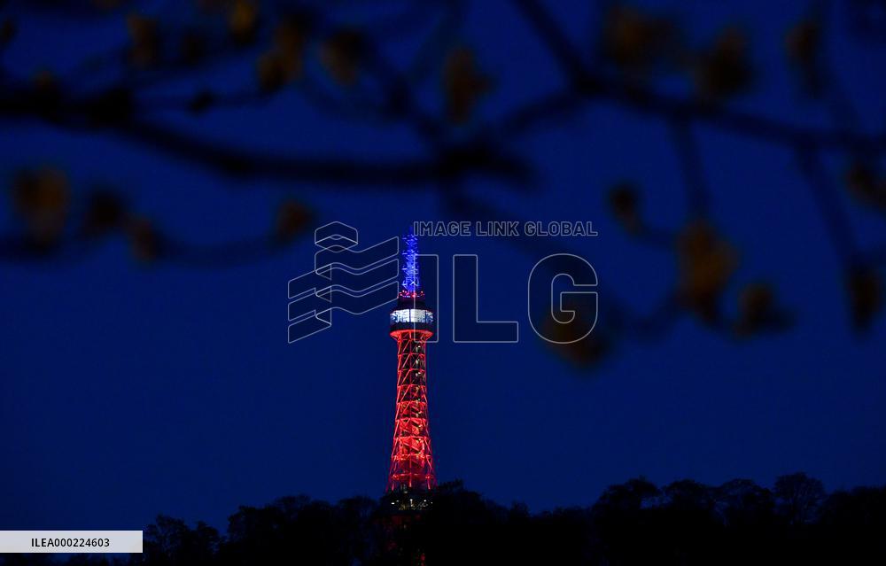The lookout tower on Petrin hill lit in the French national colours