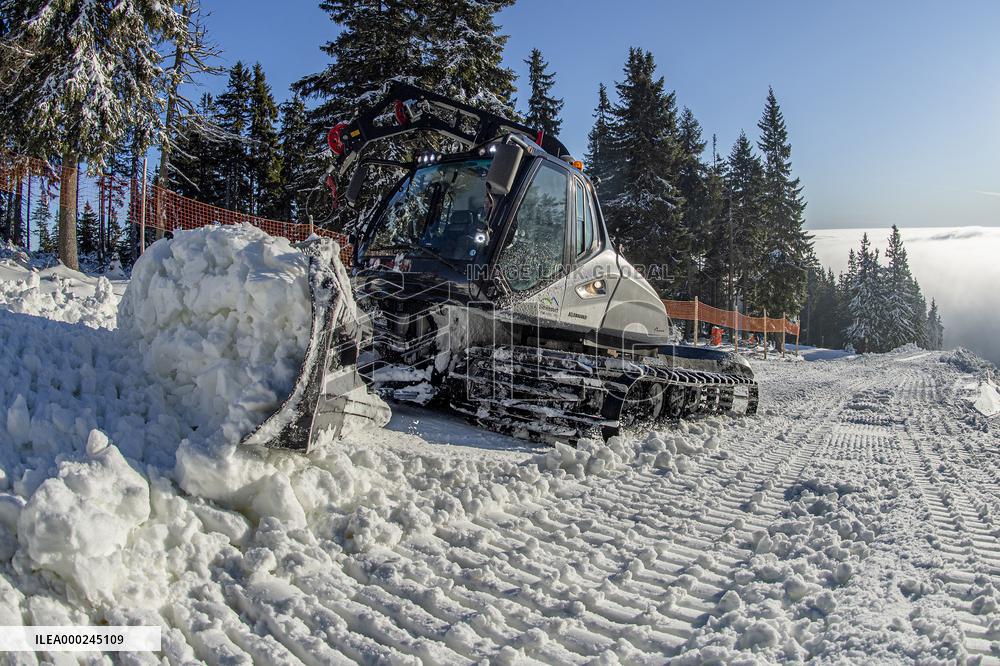 snowcat moves snow in ski resort