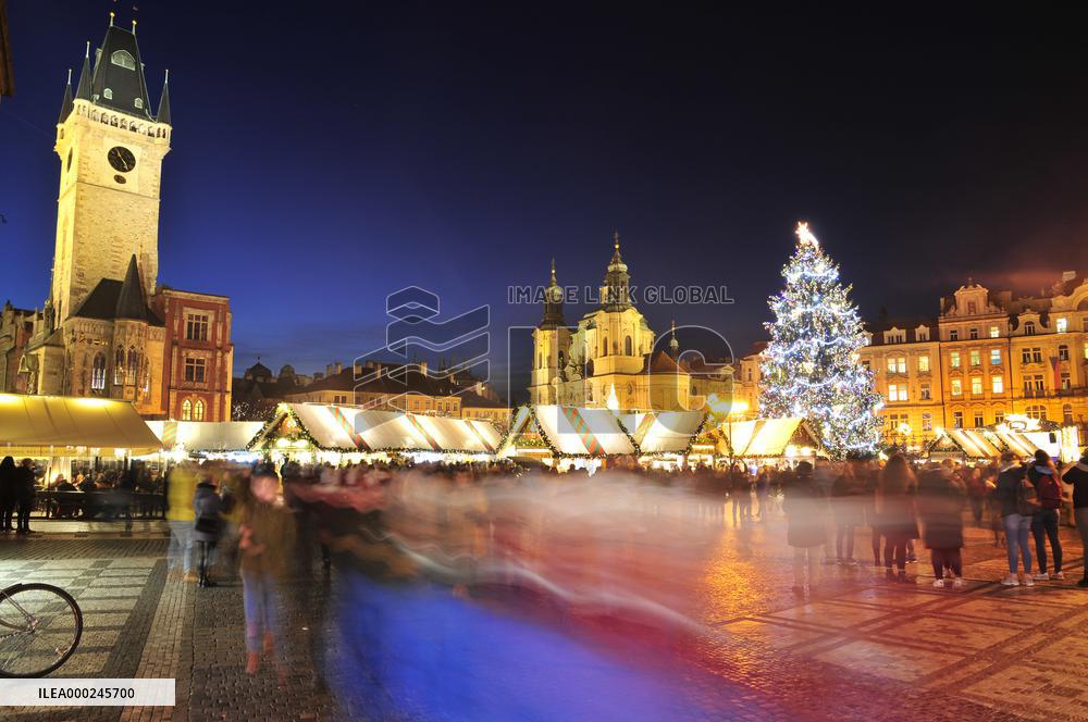 Christmas market and tree at Old Town Square in Prague, Old Town Hall, St. Nicholas Church