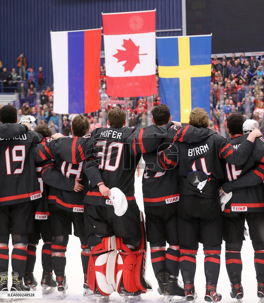 Canadian players follow the national flags of Russia, Canada and Sweden