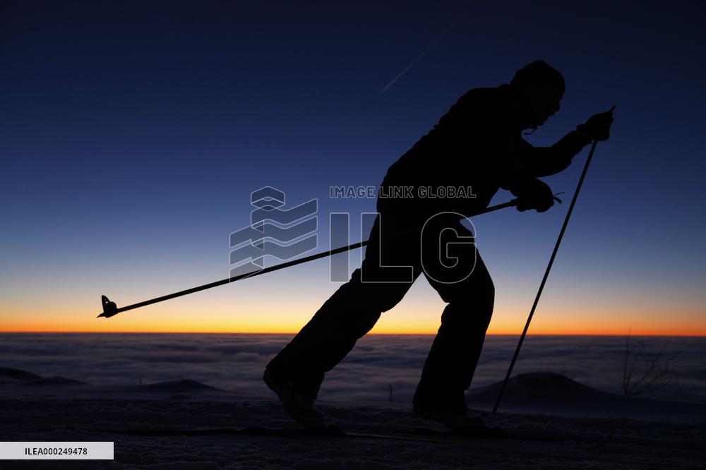 Inversion, nordic skiing, winter, snow, mountains, evening, sunset, silhouette, skier