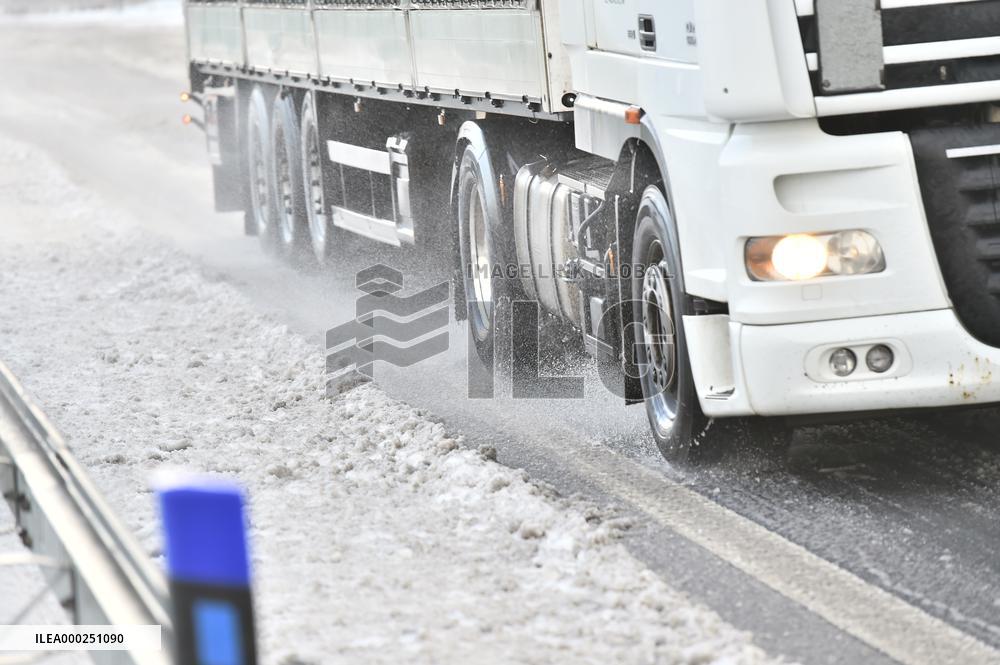 truck is slowly moving along the snow-covered D8 highway, motorway