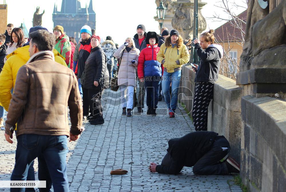 A beggar on the Charles Bridge