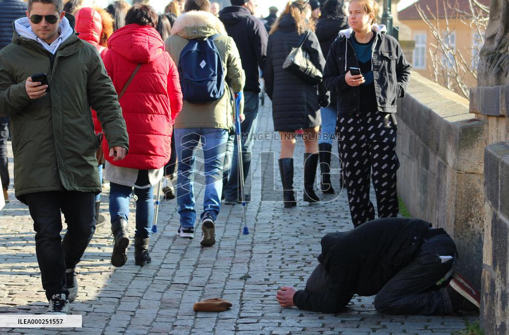 A beggar on the Charles Bridge