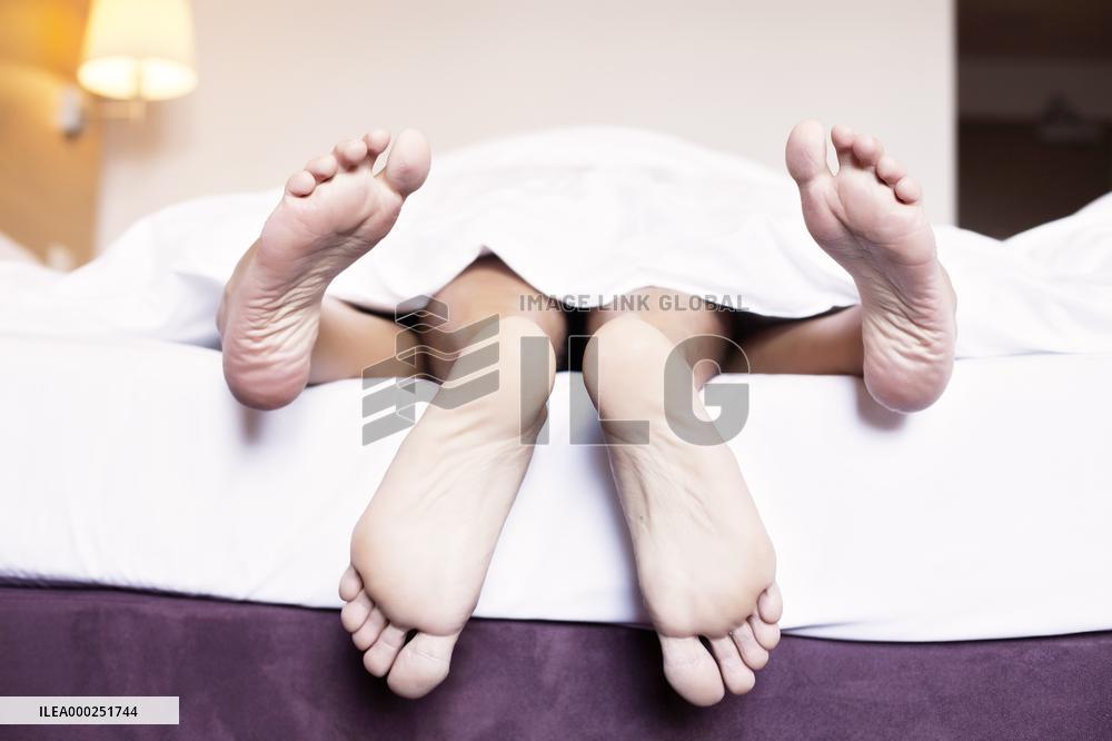 young couple in the bed, man, woman, sex, foot, feet, detail
