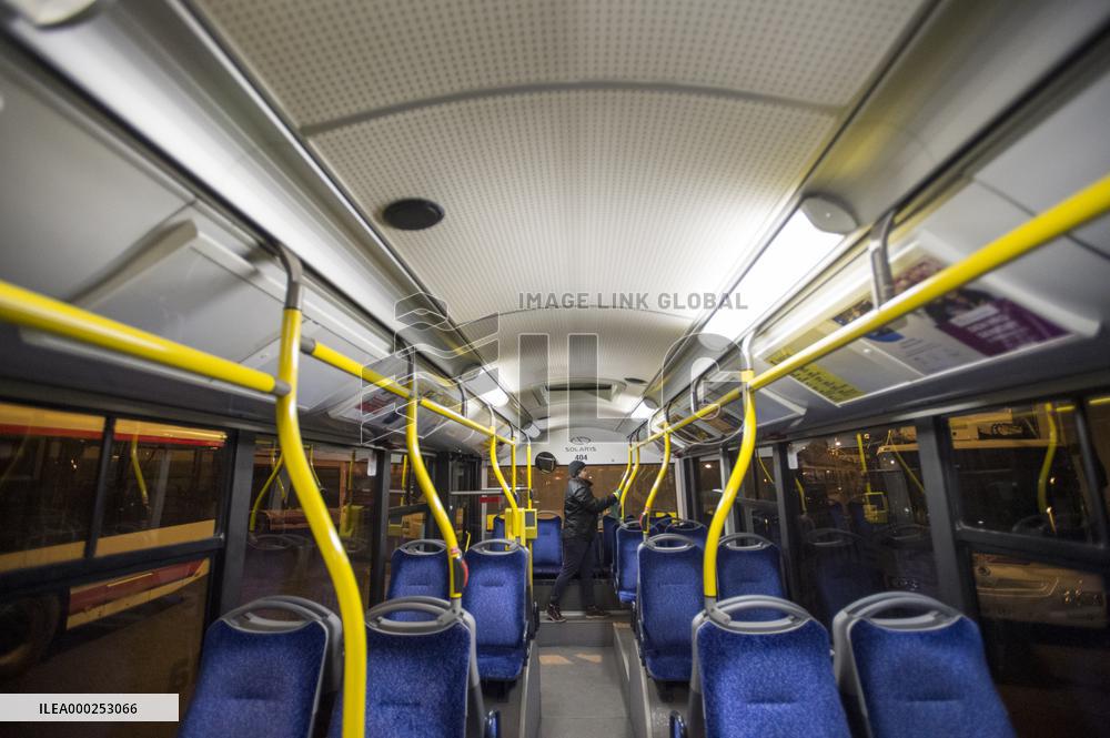 a worker disinfects a public bus against coronavirus