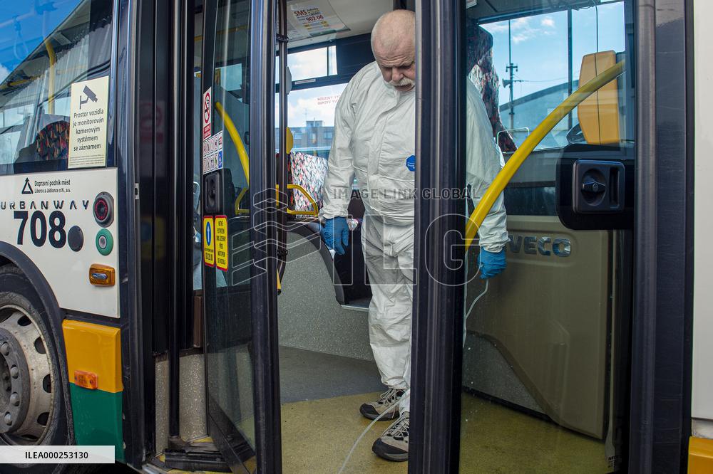 a worker with ozone disinfects a public bus against coronavirus