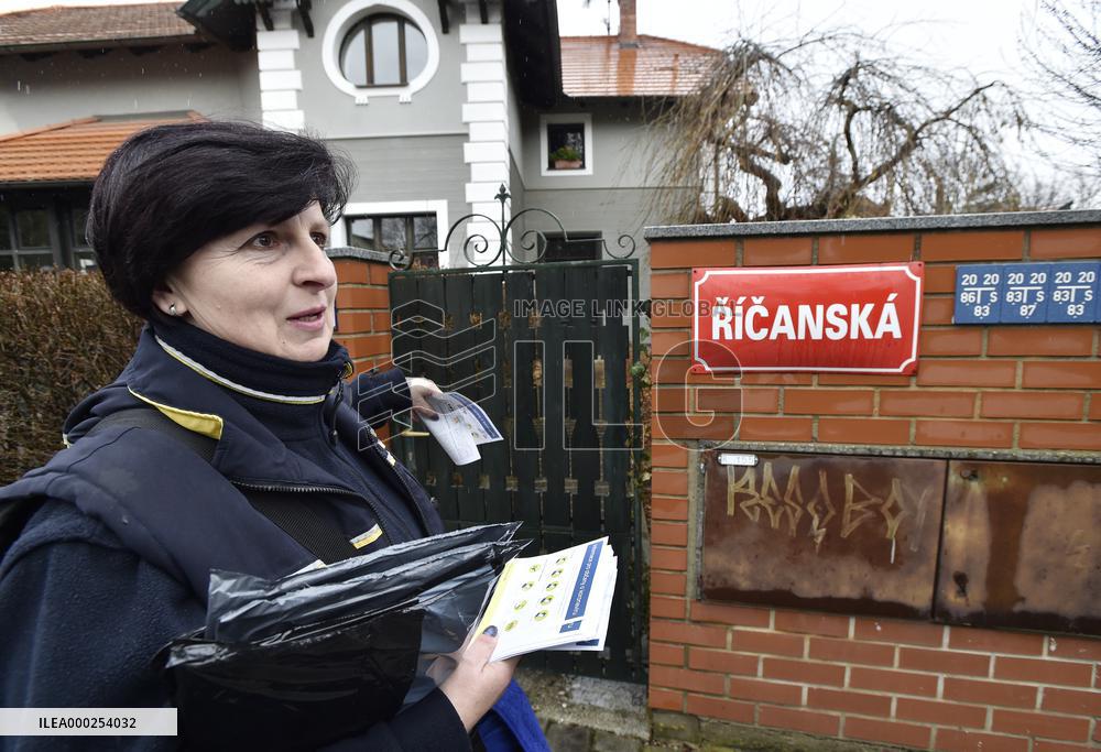 a postwoman distributes information flyers about the novel coronavirus