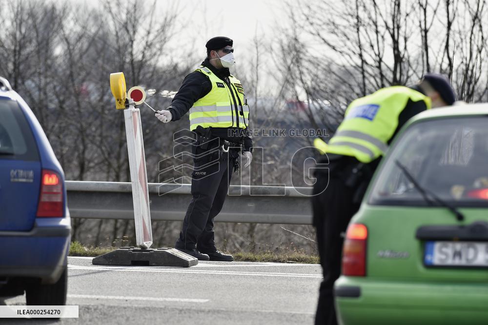 policeman, mask, control, traffic jam of trucks at the Bohumin - Chalupki crossing between Poland and the Czech Republic
