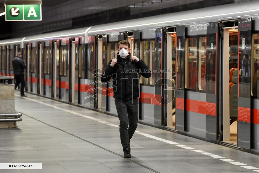 a woman with a protective medical mask in the Prague metro (subway)